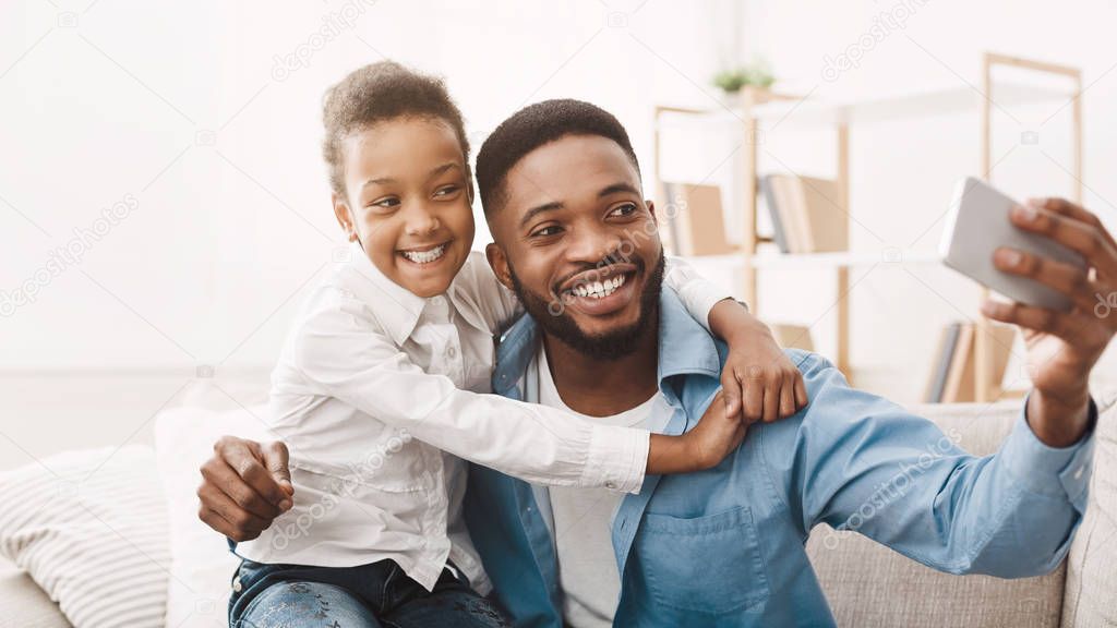 Afro Father Taking Selfie With Cute Daughter At Home