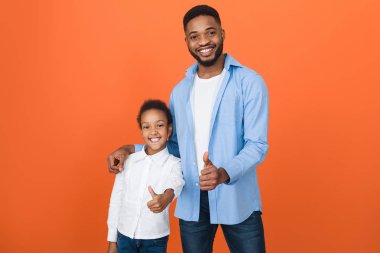 Millennial Afro Father And Cute Daughter Showing Thumbs Up clipart
