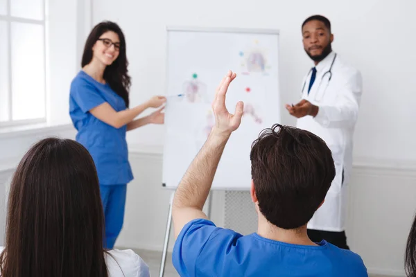 Medical Education. Doctors Giving Lecture To Interns At Seminar