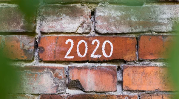 2020 concept on old bricks building, view from the bushes — Stock Photo, Image