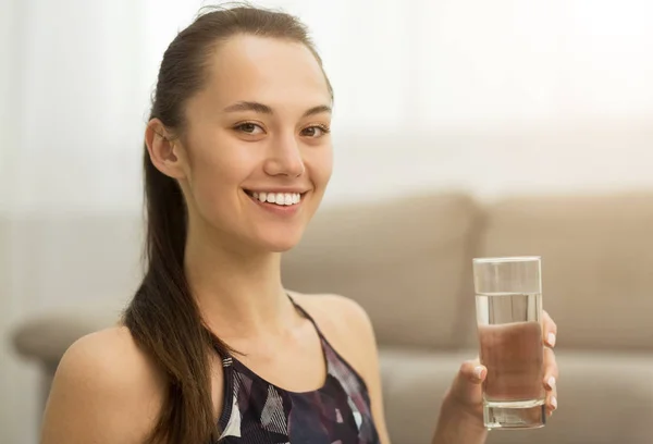 Healthcare. Girl drinking clean mineral water, side view — Stock Photo, Image
