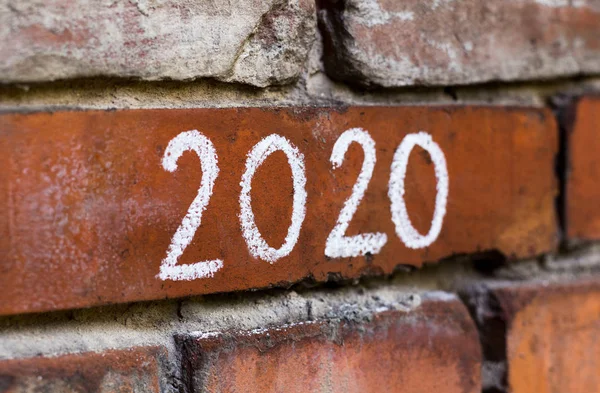 Close up of new chalk handwriting on red bricks wall — Stock Photo, Image