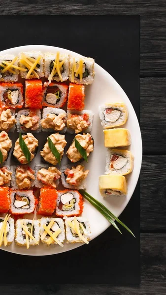 Sushi-Set für zwei Personen mit Essstäbchen auf rustikalem Holzhintergrund — Stockfoto