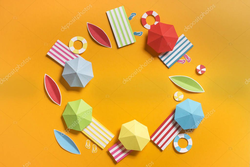Beach paradise. Summer background with round composition of beach accessories on yellow, copy space