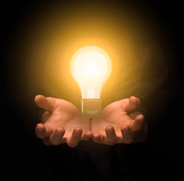 Women hands holding lightbulb in the darkness — Stock Photo, Image