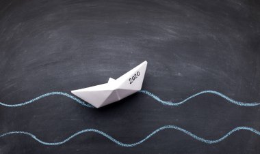 Siyah tahta arka planda 2020 konsepti olan beyaz kağıt tekne