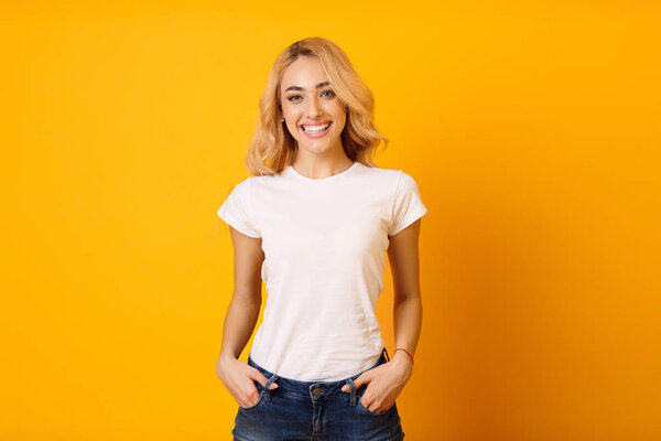 Millennial Woman In White T-Shirt On Yellow Background