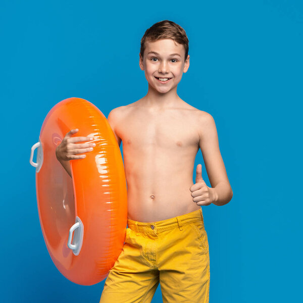Friendly boy showing like gesture, approving safety swimming
