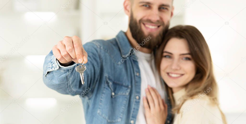 Real Estate Concept. Couple Holding New House Keys