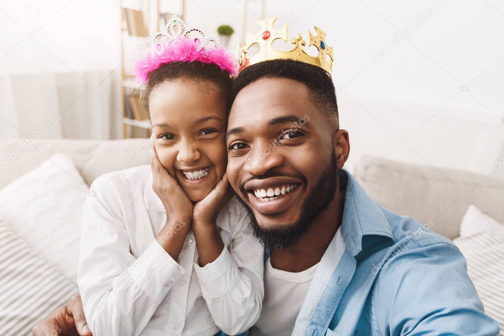 Play Princess. Father and Daughter In Crowns Taking Selfie