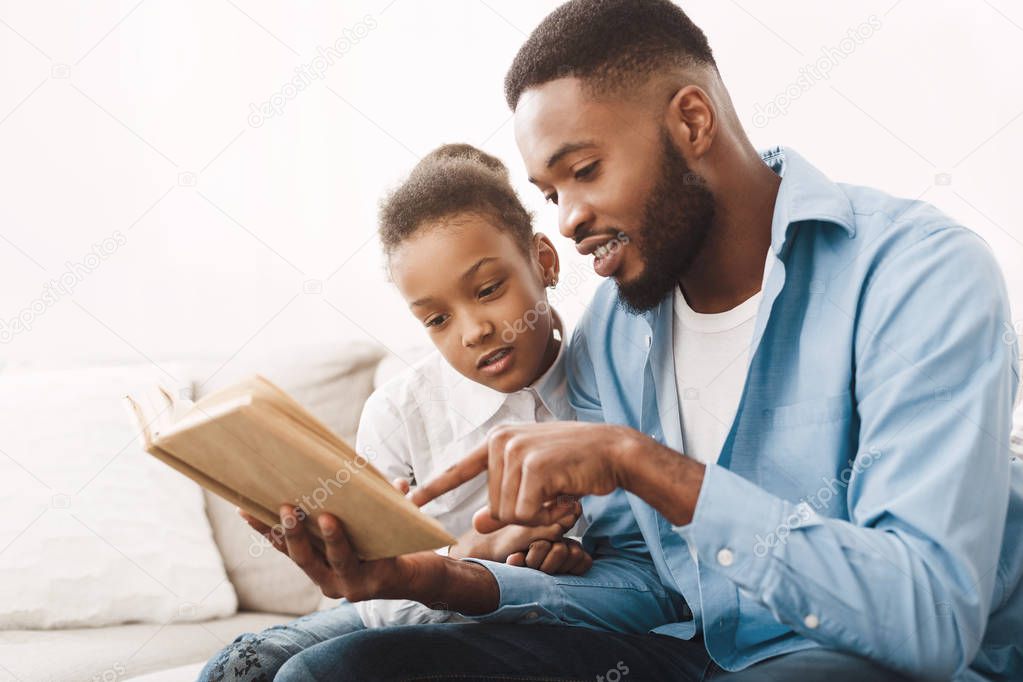 Reading Together. Cute Girl And Father Enjoying Time Together
