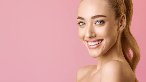 Girl with Clean Skin And Beaming Smile Looking At Camera