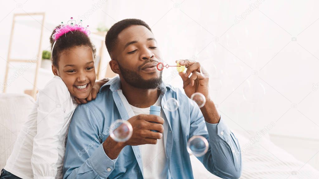 Play With Father. Dad And Daughter Blowing Soap Bubbles
