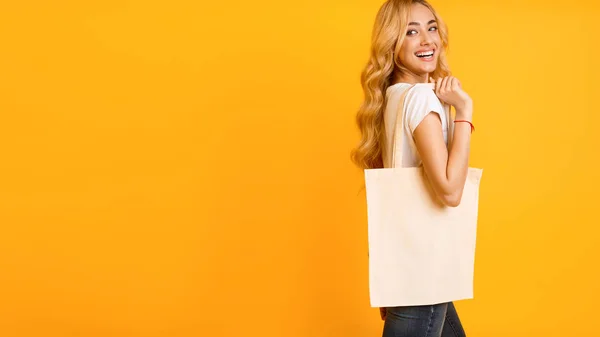 Girl With Cotton Bag Over Yellow Background — Stock Photo, Image