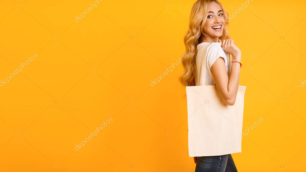 Mockup For Design. Girl With Cotton Bag Over Yellow Background, Free Space