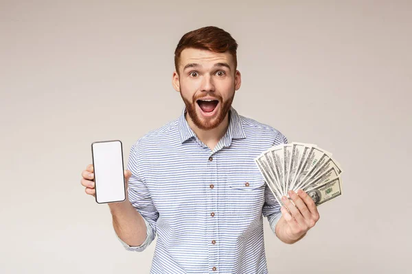 Surprised millennial guy with money and cellphone