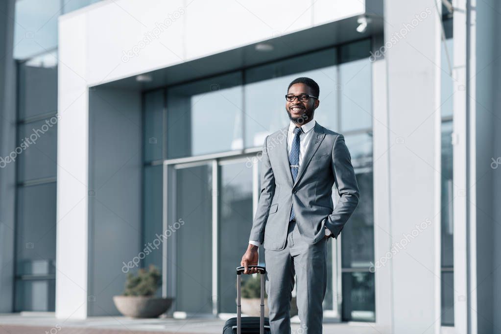 Business Trip. Happy Manager Walking with Suitcase Outside