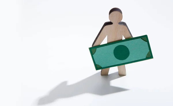 Houten man met dollars staande op witte achtergrond — Stockfoto