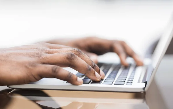 Close up of young african american guy typing on laptop — Stock Photo, Image