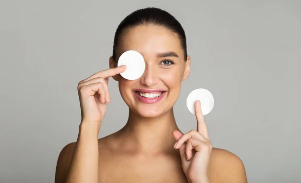 Skin Care. Girl Removing Makeup with Cotton Pads