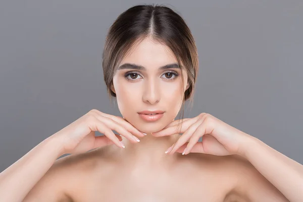 Young beautiful woman with perfect skin massaging her face — Stock Photo, Image