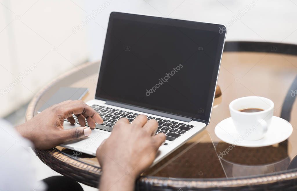 Unrecognizable african american man using laptop with blank