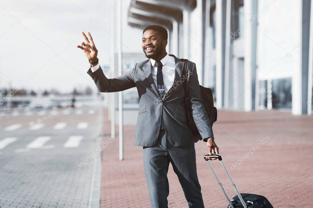Catch Taxi. Afro Businessman Calling Cab in Airport