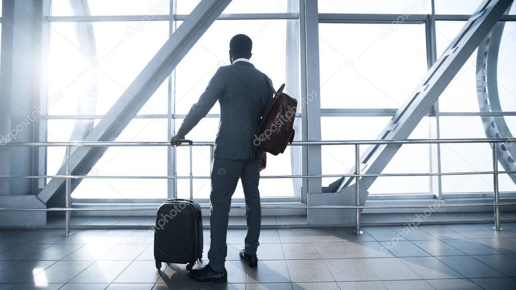 Business Trip. Afro Businessman at Airport Terminal Boarding Gate