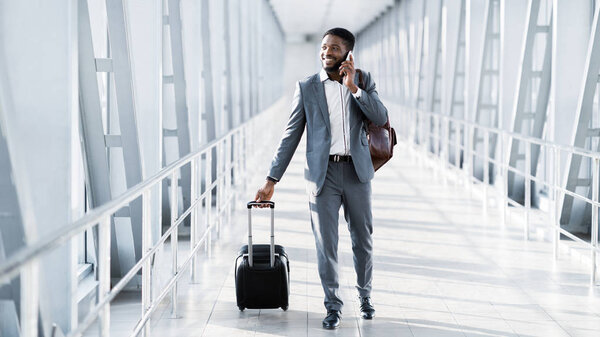 Busy Businessman Traveller Talking on Phone, Walking Inside Airport