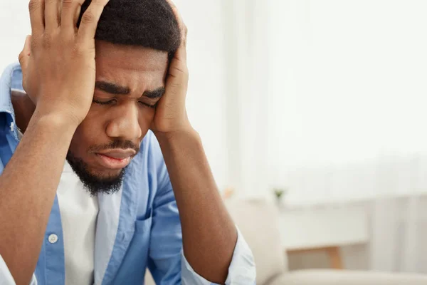 Lonely depressed man near window at home — Stock Photo, Image