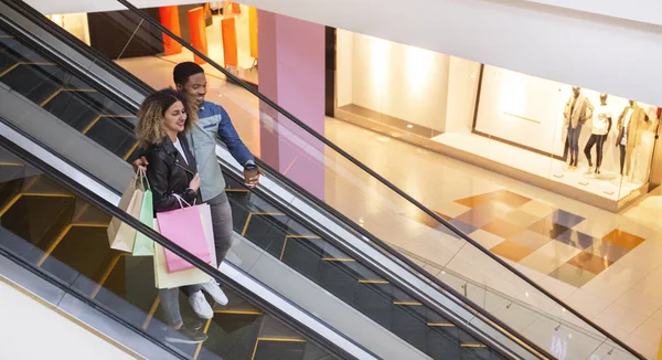 African couple having after shopping coffee in mall — Stock Photo, Image