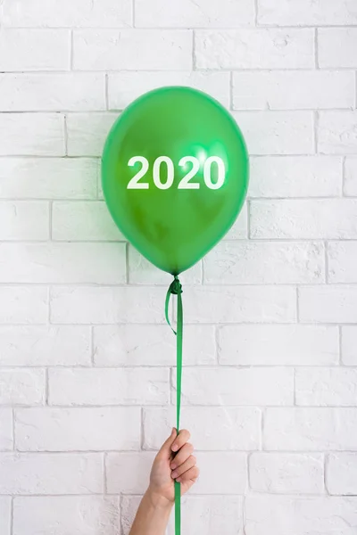 Helder groene ballon met 2020 concept in vrouw hand op wit — Stockfoto