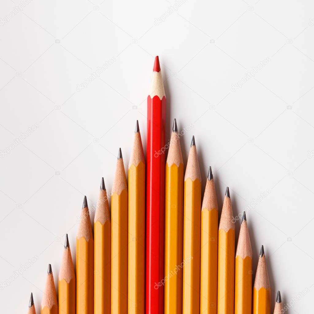One red pencil leading similars crowd on white background