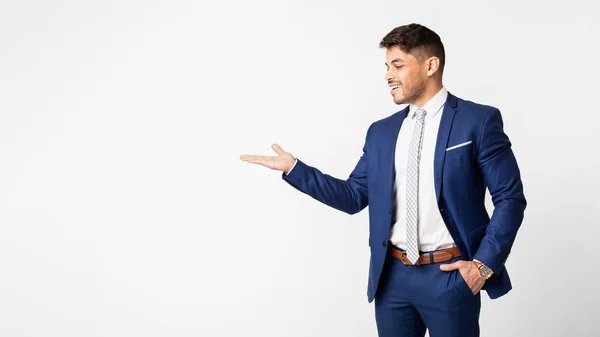 Smiling Businessman Presenting Something On Empty Palm Over White Background — Stock Photo, Image