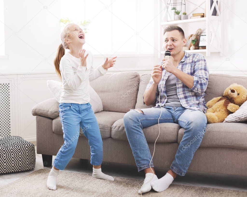 Little girl is laughing of her father singing