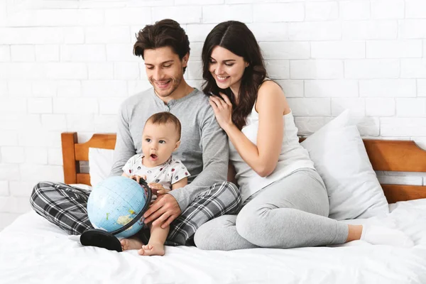 Happy Family bereidt zich voor op reis reis, leer voor route op Globe — Stockfoto