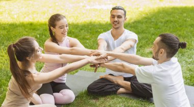 Başarılı yoga uygulamasından sonra el ele tutuşan dört arkadaş