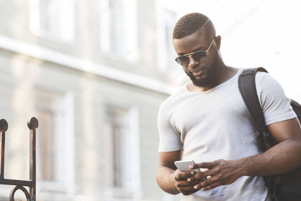 Concentrated african man checking flying departure online