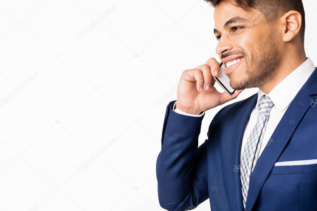 Portrait Of Latin Businessman Having Phone Conversation, Isolated On White
