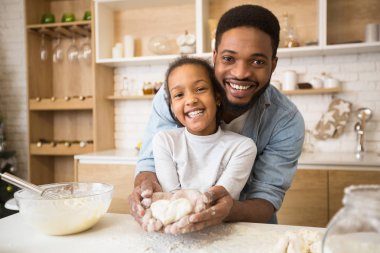 Afro adam içinde kalp şeklinde pasta ile kızı el ele tutuşan