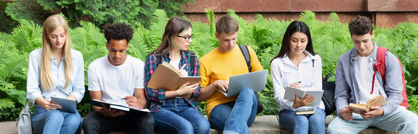 Preparing for lecture. Teens sitting in university campus