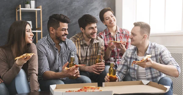 À la maison. Groupe d'amis manger de la pizza, boire de la bière et parler — Photo