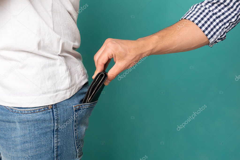 Man Fishing Out Wallet From Jeans Back Pocket, Closeup