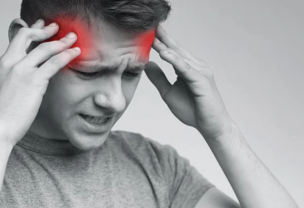 Hombre sufriendo de dolor de cabeza, tocando sus sienes —  Fotos de Stock