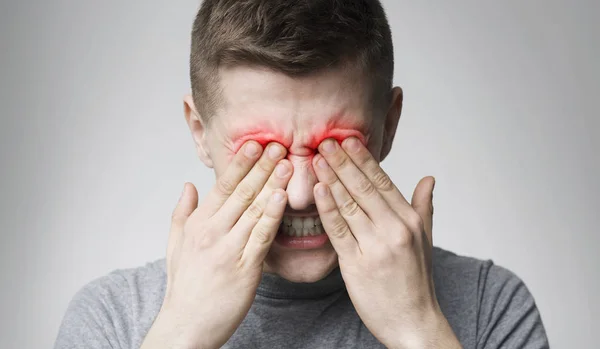 Uomo stanco che soffre di dolore agli occhi, strofinando zona dolorante rossa — Foto Stock