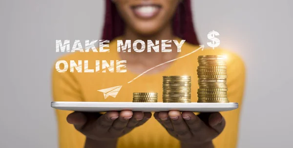 African woman holding in hands tablet with coins on it — Stock Photo, Image