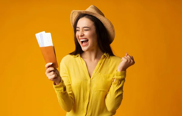 Gladful Woman Traveler Holding Tickets and Passport Over Yellow Background — стоковое фото