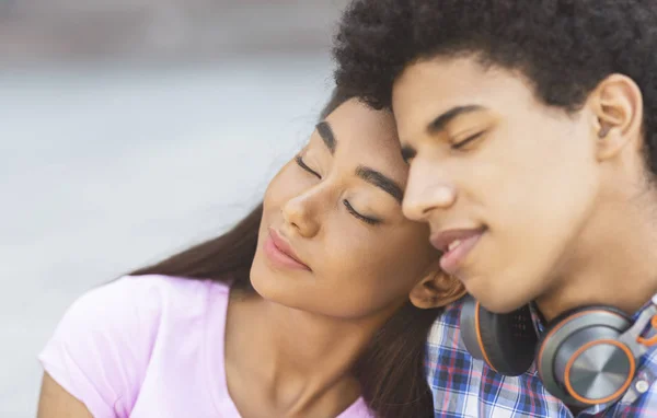 Romantic moment. Dreamy teen couple sitting with their eyes closed — Stock Photo, Image