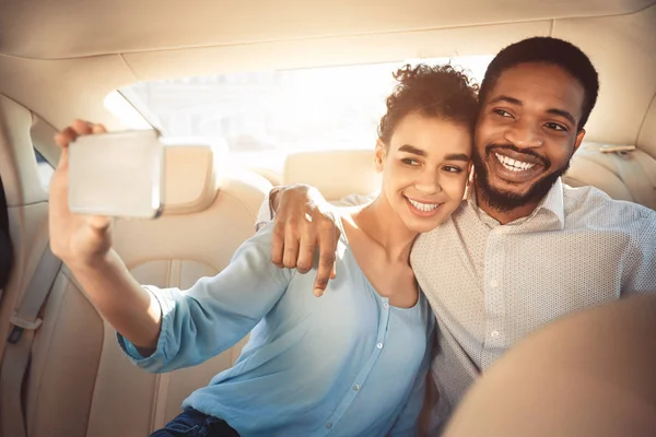 Amando pareja afroamericana tomando selfie, conduciendo en coche —  Fotos de Stock