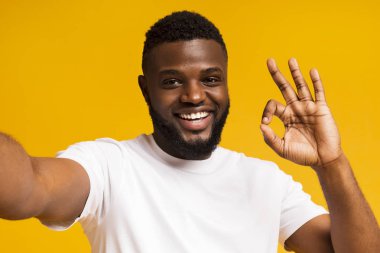 Afrikalı adam selfie yapıyor ve kameraok işareti gösteren